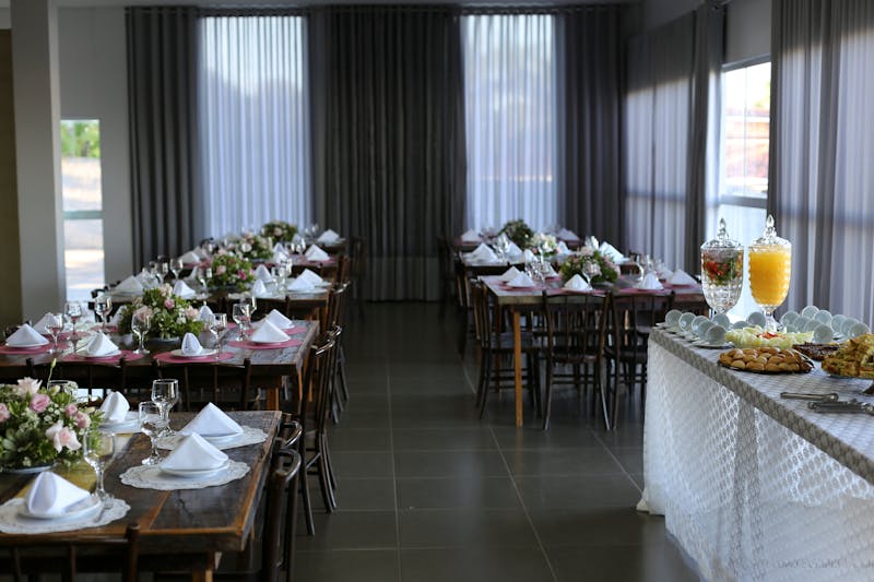 Catering table setup with multiple Detroit-style pizzas for an event